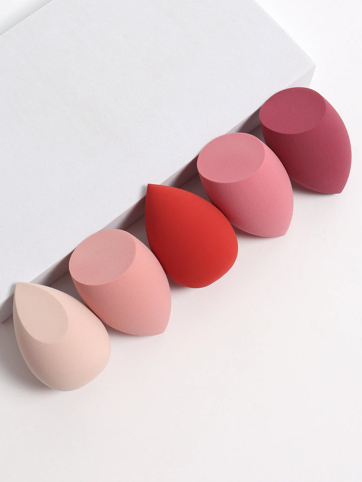 Bags of Beauty Eggs Makeup - Ensemble d'éponges de maquillage en différentes teintes sur fond blanc.